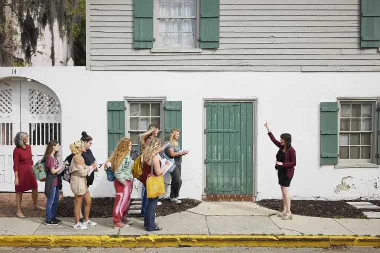 A faculty member leads a group on a tour in historic downtown St. Augustine.