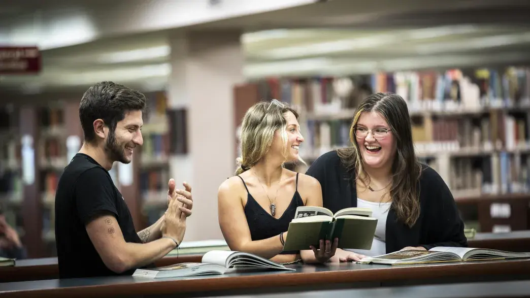 Students share a laugh in the library