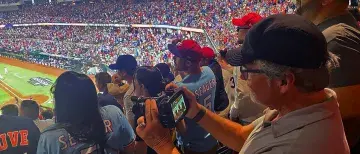Jim Gilmore taking video at a baseball game