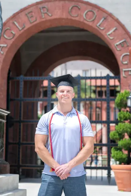 Shane Nelson standing in front of the gates at the Ponce entrance