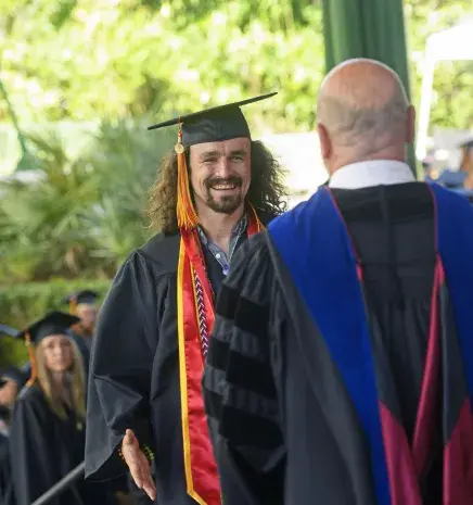 Jake crossing stage at Commencement