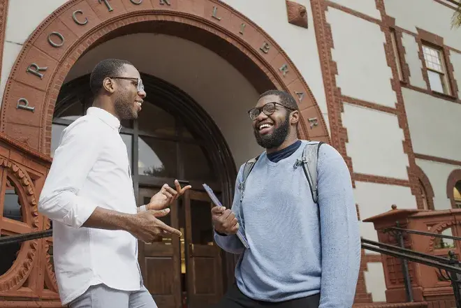 Faculty and student working together in front of the proctor library