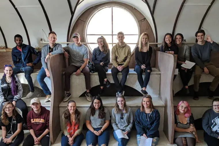 Flagler College art history students inside a historic building.