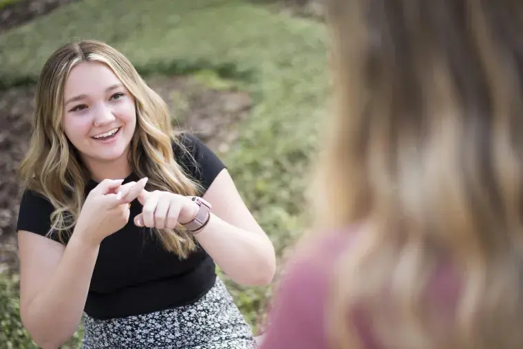 A student practices sign language.