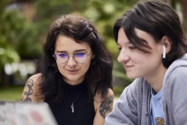 Two Flagler College students work on a project together.