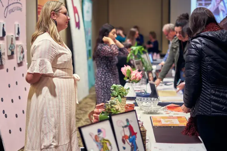 A Flagler College student displays her colorful work.