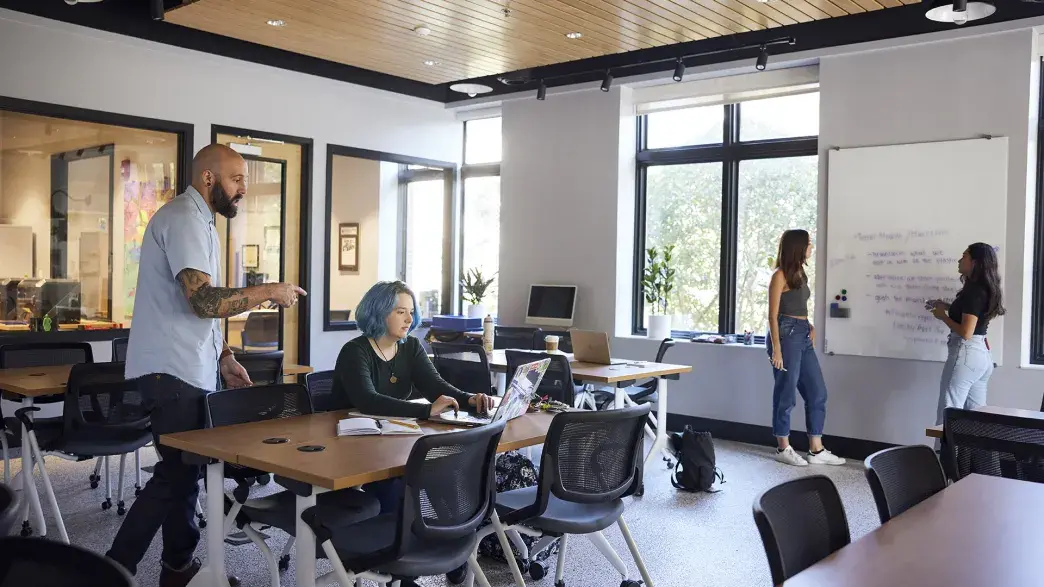 Students and faculty discussing academic topics in the Innovation Center