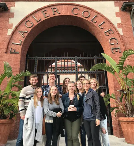 Group of students standing at the entrance of Flagler College.