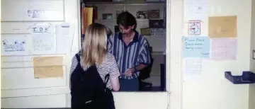 Terry Bennett helping student in the old mailroom