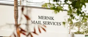 'Mernik Mail Services' building sign