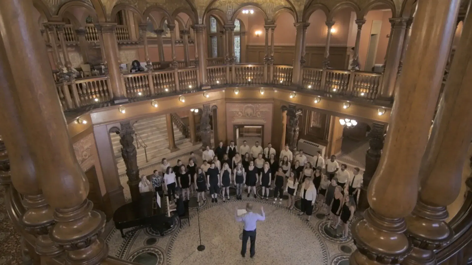 Chorus sings the Alma Mater in the Ponce Rotunda