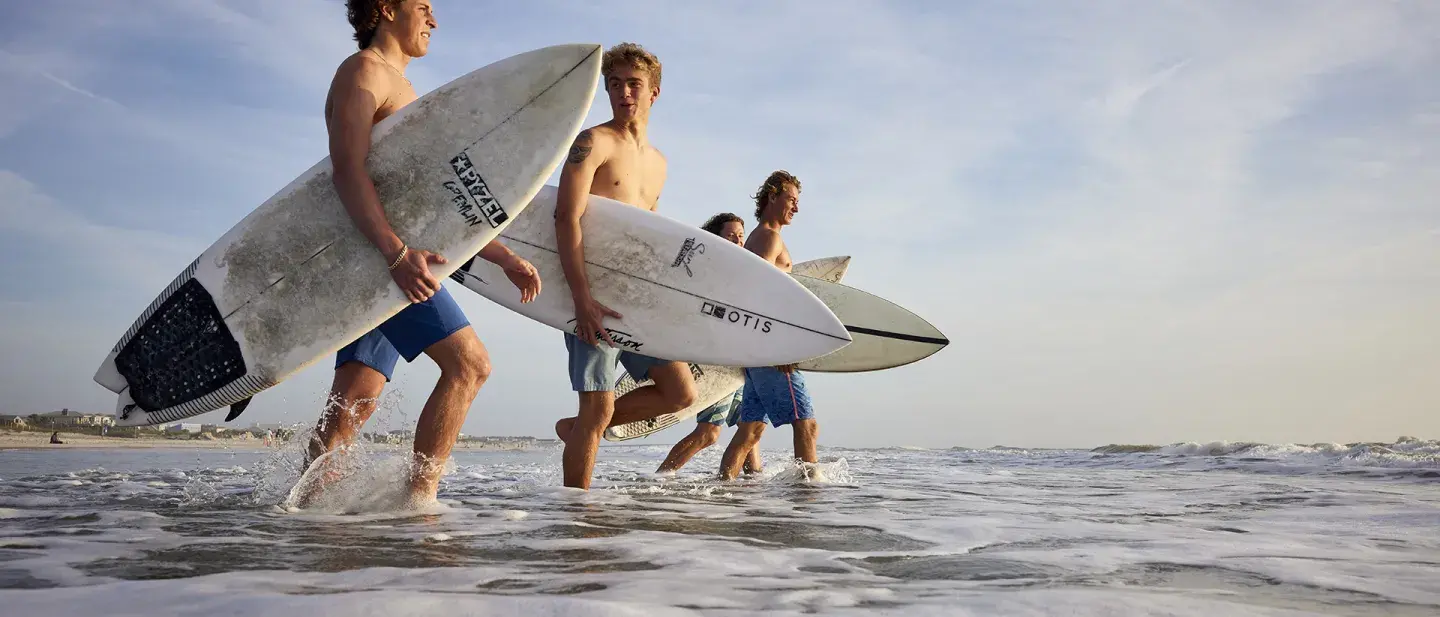 Student surfers going out to catch a wave